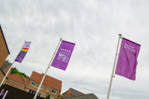 trio of Taylor Wimpey flags on Harrison Flagpoles housebuilder poles at a housing development