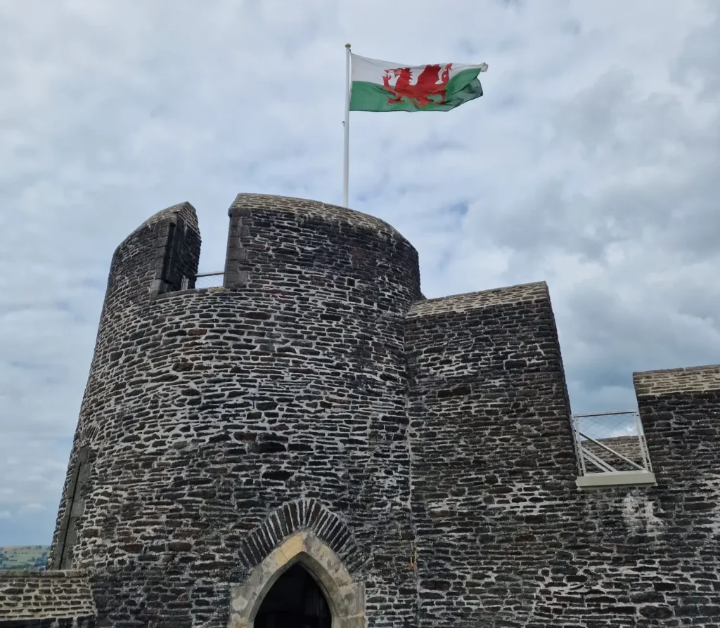 Caerphilly castle tower with Welsh Cymru flag