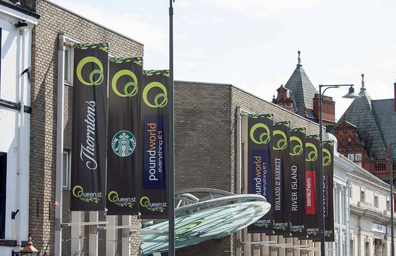 Wall mounted banner poles at shopping complex
