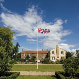 Straight glassfibre flagpole for a garden with a gold finial