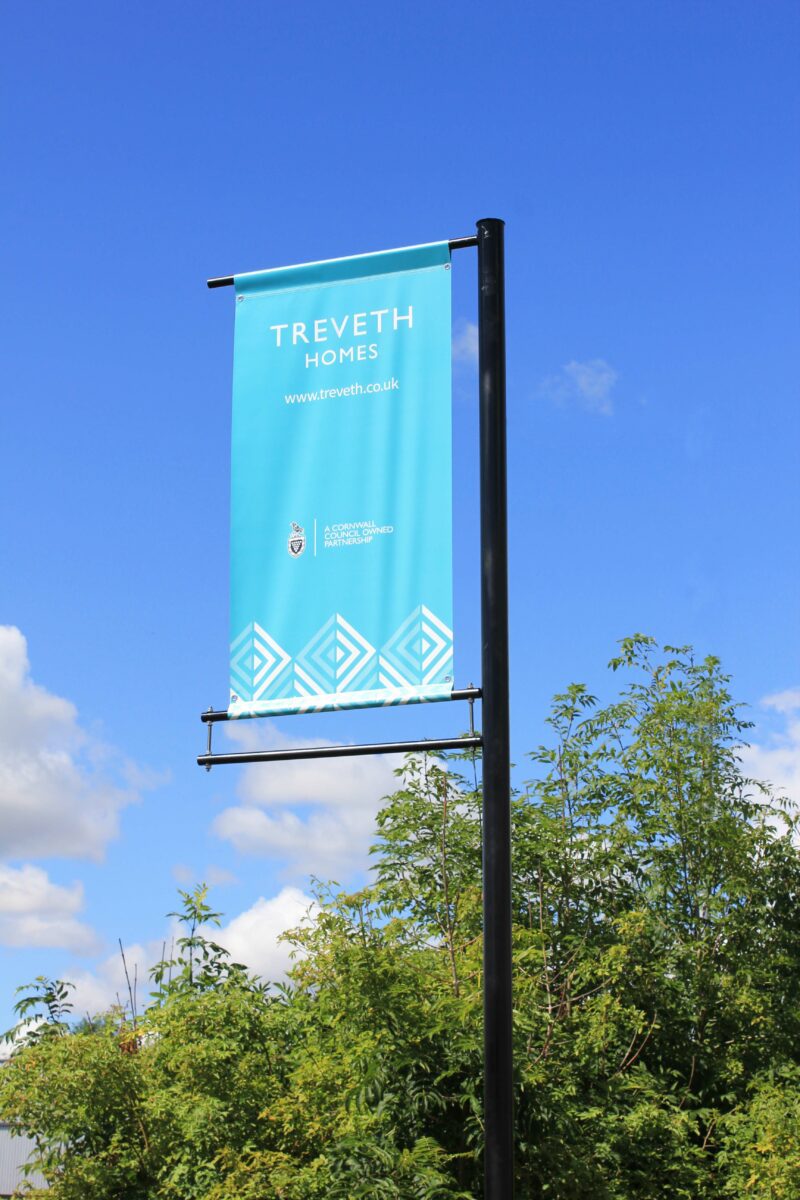 black banner pole with blue PVC banner